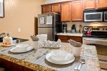 The updated kitchen is well-equipped with stainless steel appliances and modern amenities